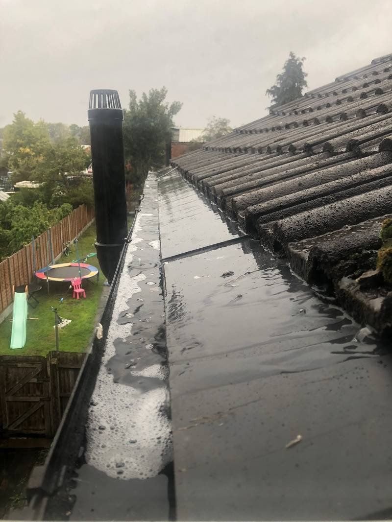 Gutters before clearing — blocked with debris