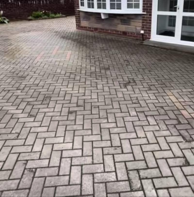 Herringbone driveway before cleaning — oil stains
